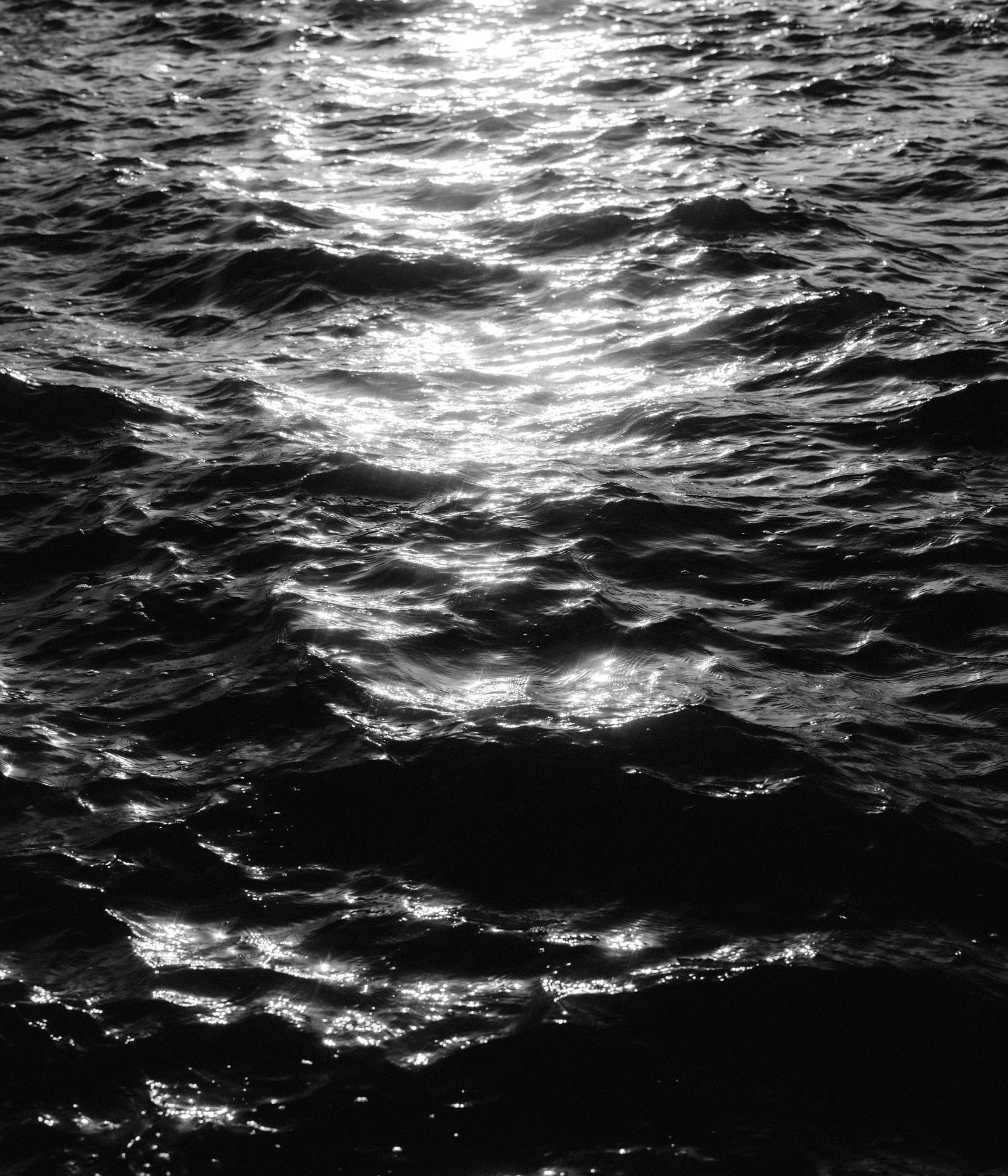black and white ocean at sunset